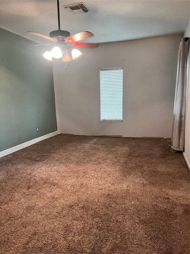 unfurnished room featuring carpet flooring, visible vents, and a ceiling fan