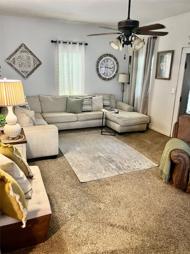 living room with carpet flooring, a ceiling fan, and baseboards