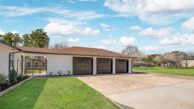 garage with a gate and driveway