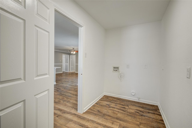 corridor with wood finished floors and baseboards