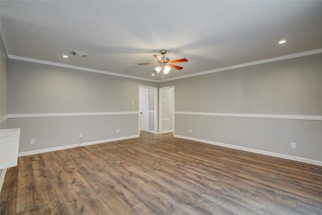 spare room featuring ornamental molding, wood finished floors, visible vents, and baseboards