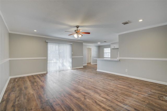 unfurnished living room featuring ornamental molding, visible vents, baseboards, and wood finished floors