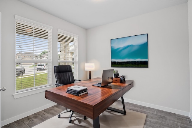 office area with baseboards and wood finished floors