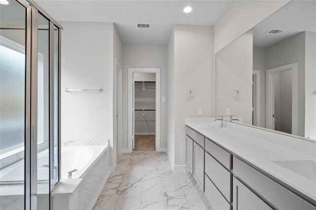 bathroom featuring marble finish floor, baseboards, visible vents, and a sink