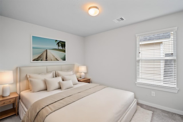 carpeted bedroom featuring visible vents and baseboards
