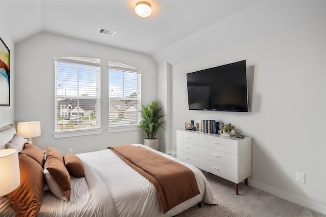 bedroom featuring light carpet, baseboards, visible vents, and vaulted ceiling