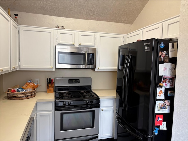 kitchen with a textured ceiling, stainless steel appliances, light countertops, and white cabinets