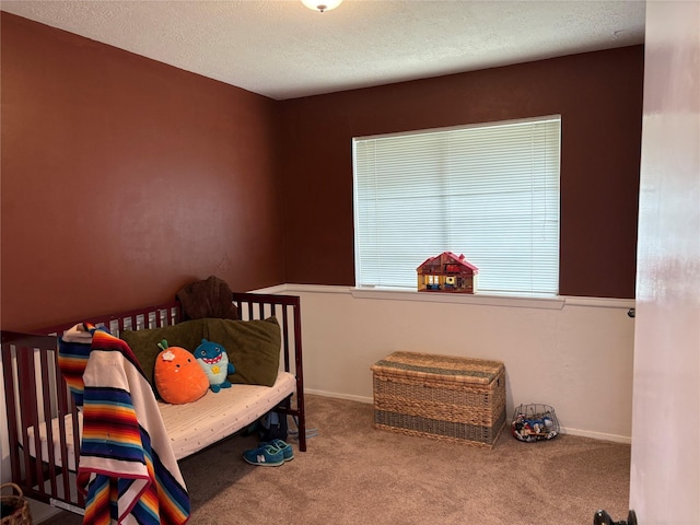 carpeted bedroom with a textured ceiling and baseboards