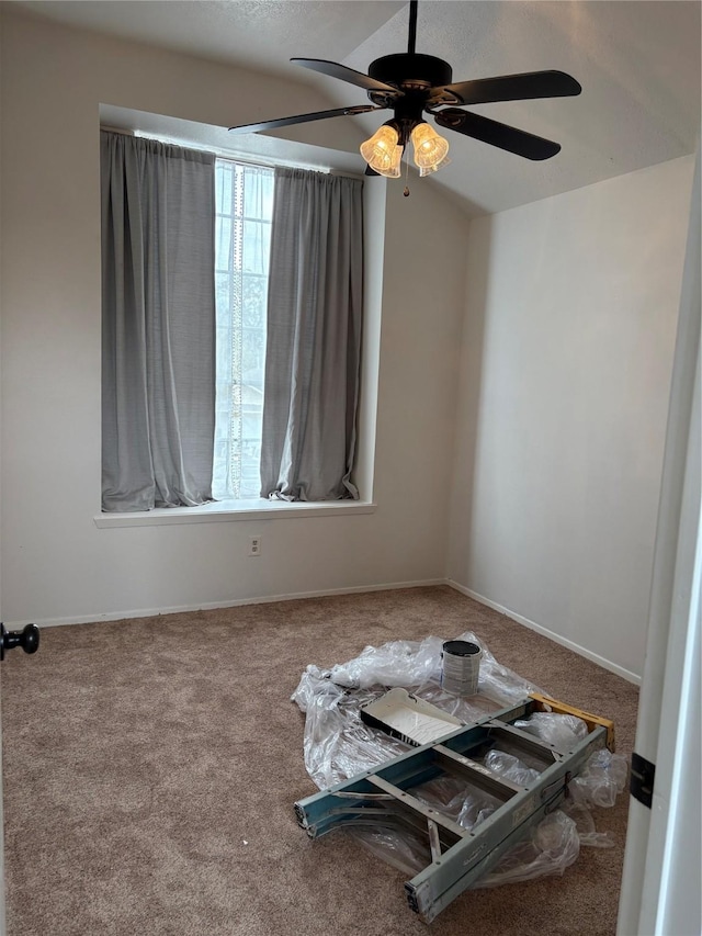 spare room featuring carpet and baseboards