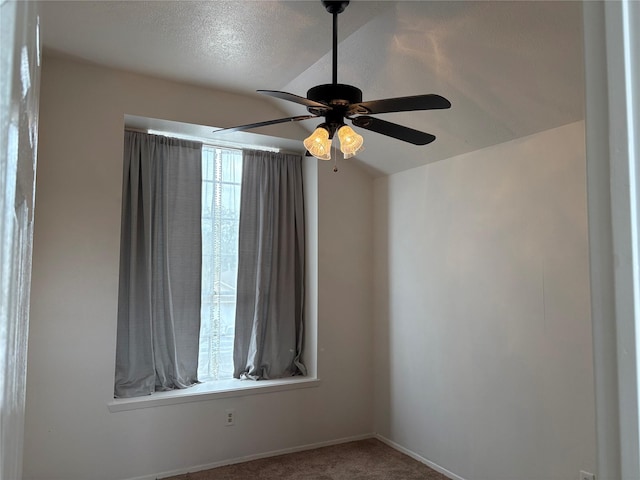 unfurnished room featuring carpet floors, a ceiling fan, and a textured ceiling