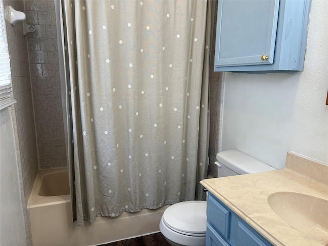 full bath featuring vanity, shower / bath combo with shower curtain, and toilet