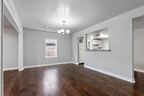 interior space featuring a notable chandelier, baseboards, and wood finished floors