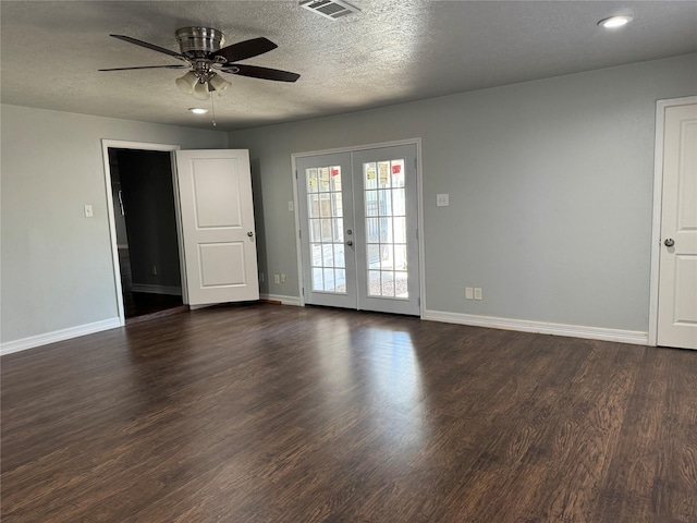 spare room featuring french doors, dark wood finished floors, ceiling fan, a textured ceiling, and baseboards