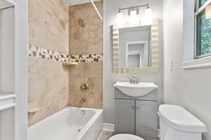 bathroom featuring toilet, tub / shower combination, and vanity