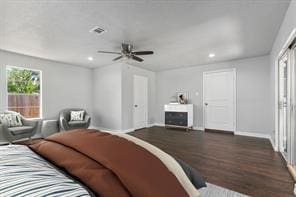 bedroom with a fireplace, baseboards, dark wood-style flooring, and recessed lighting