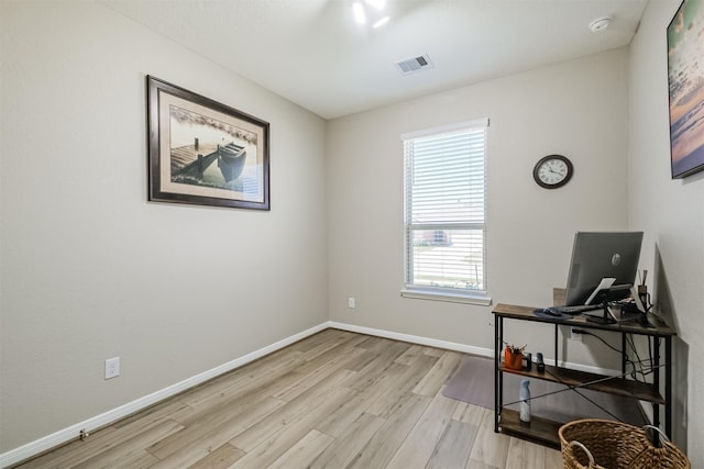 living area with light wood-style flooring, baseboards, and visible vents