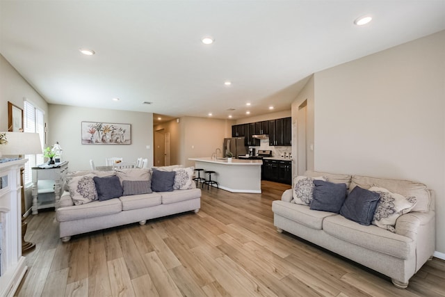 living area featuring recessed lighting and light wood-type flooring