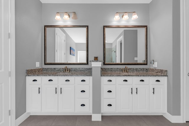 bathroom with two vanities, a sink, and tile patterned floors