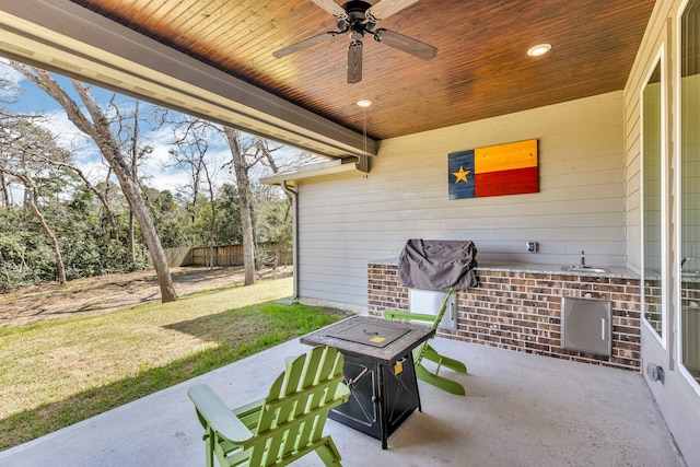 view of patio with ceiling fan and fence