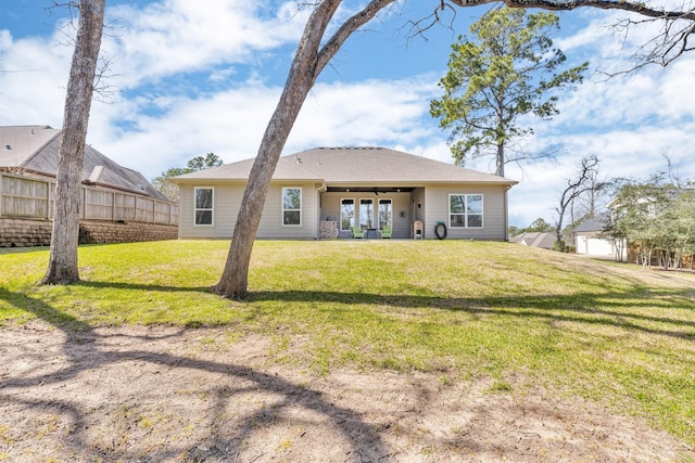 back of house with a lawn