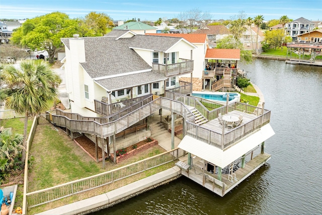 drone / aerial view with a water view and a residential view