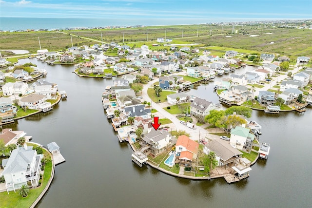 drone / aerial view with a residential view and a water view