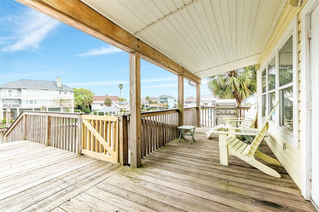 deck with a residential view and grilling area