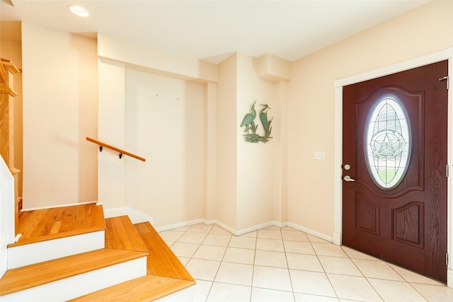 foyer with stairs, recessed lighting, light tile patterned flooring, and baseboards