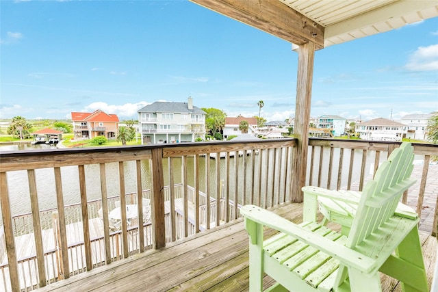 deck with a water view and a residential view