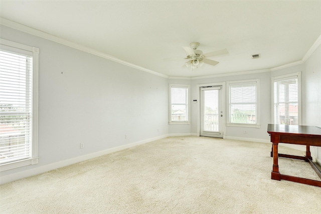 interior space featuring light colored carpet, visible vents, ornamental molding, ceiling fan, and baseboards