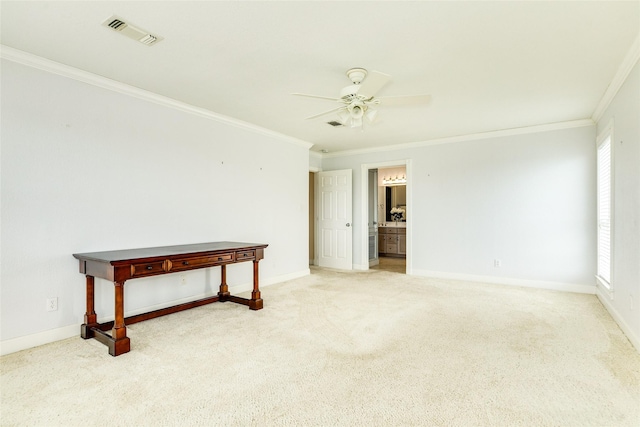 empty room featuring ceiling fan, visible vents, baseboards, carpet, and crown molding