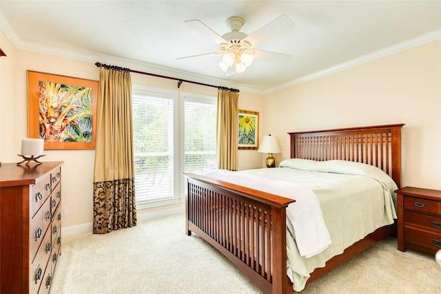 bedroom featuring light carpet, ceiling fan, baseboards, and crown molding