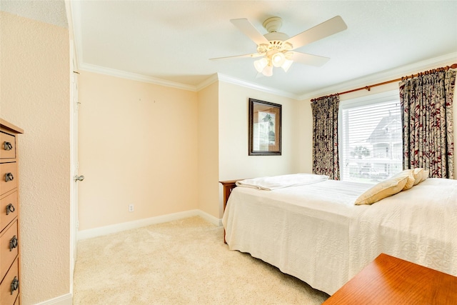 bedroom featuring baseboards, a ceiling fan, light colored carpet, and crown molding