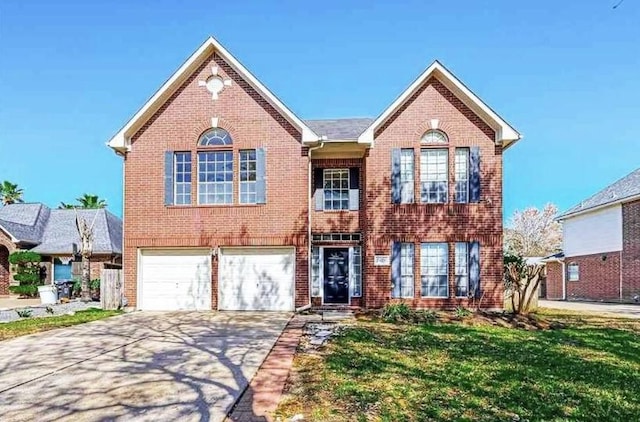 view of front of house featuring a garage, concrete driveway, brick siding, and a front yard