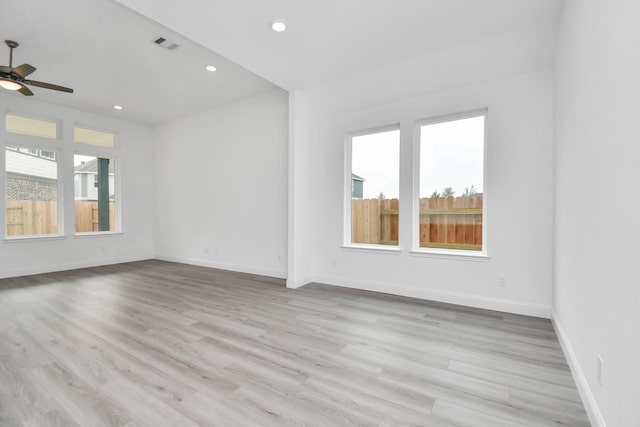 unfurnished room with visible vents, baseboards, wood finished floors, and recessed lighting