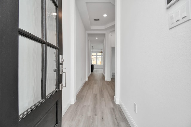 corridor with recessed lighting, visible vents, light wood-style flooring, and baseboards