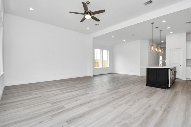 unfurnished living room with light wood finished floors, ceiling fan, visible vents, and recessed lighting