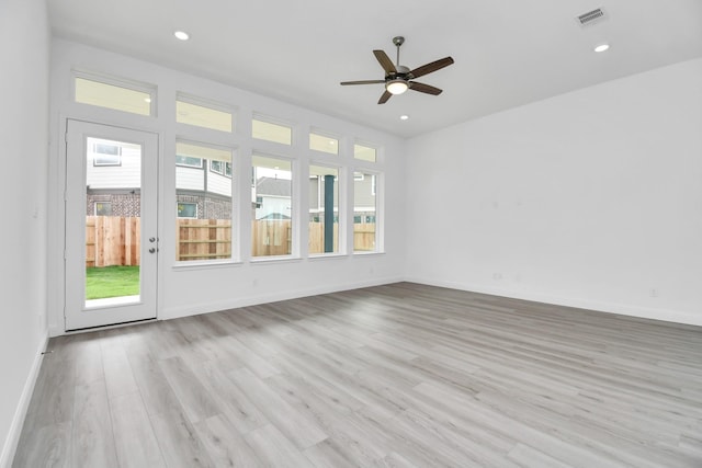 spare room with recessed lighting, visible vents, a ceiling fan, wood finished floors, and baseboards