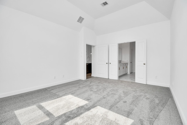 unfurnished bedroom featuring carpet, visible vents, ensuite bath, and baseboards