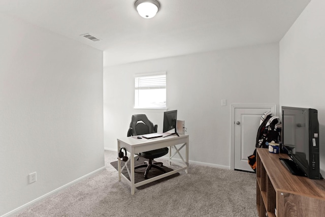 carpeted office space featuring visible vents and baseboards