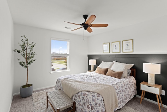 carpeted bedroom featuring visible vents, ceiling fan, and baseboards