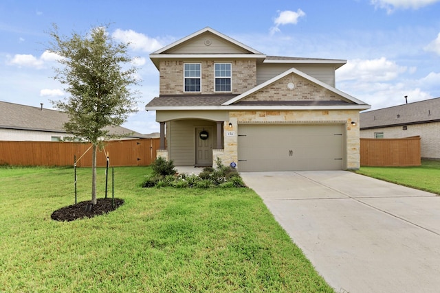 traditional-style home with a garage, brick siding, fence, driveway, and a front yard