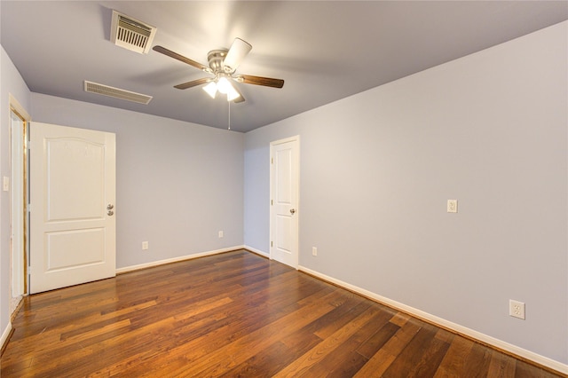 unfurnished room with ceiling fan, wood finished floors, visible vents, and baseboards