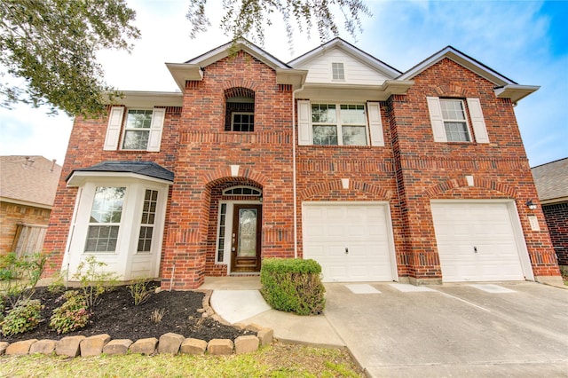 view of front of property with a garage, brick siding, driveway, and a balcony