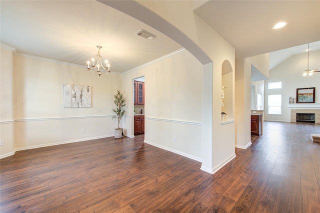 unfurnished room with baseboards, visible vents, a tiled fireplace, dark wood-type flooring, and ceiling fan with notable chandelier