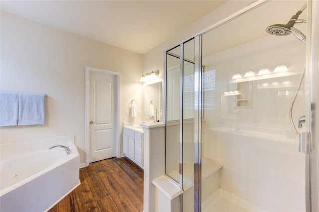 full bathroom featuring a shower stall, a bath, and vanity