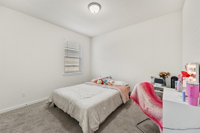 bedroom featuring carpet flooring and baseboards