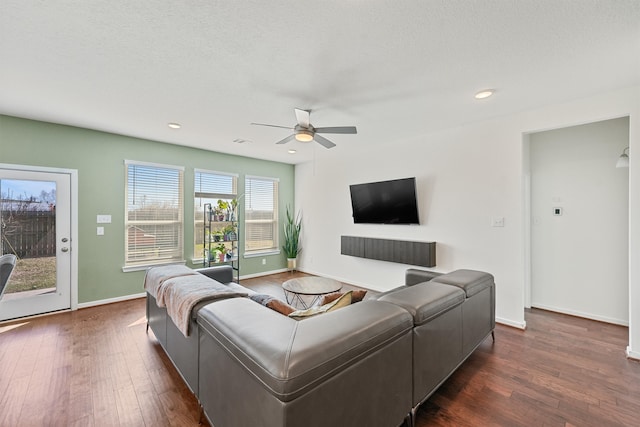 living room with visible vents, baseboards, ceiling fan, dark wood-type flooring, and recessed lighting