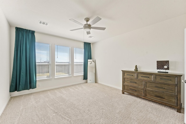 carpeted bedroom featuring ceiling fan, visible vents, and baseboards