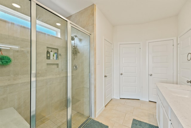 full bathroom featuring a shower stall, tile patterned flooring, and vanity